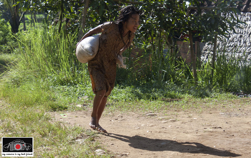 Girl carrying sand