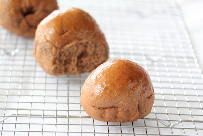 photo of three rolls on a baking rack