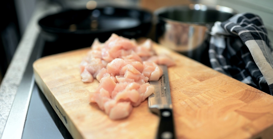 Safely handling raw chicken when cooking.