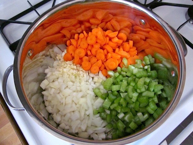 chopped mirepoix (carrots, garlic, onion and celery) in pot 