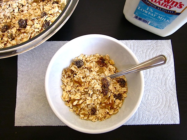 muesli served in white bowl with spoon 