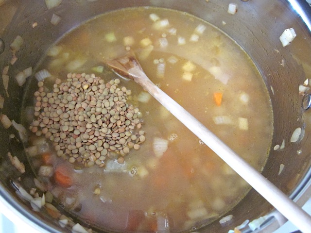 lentils and water added to veggies in pot 