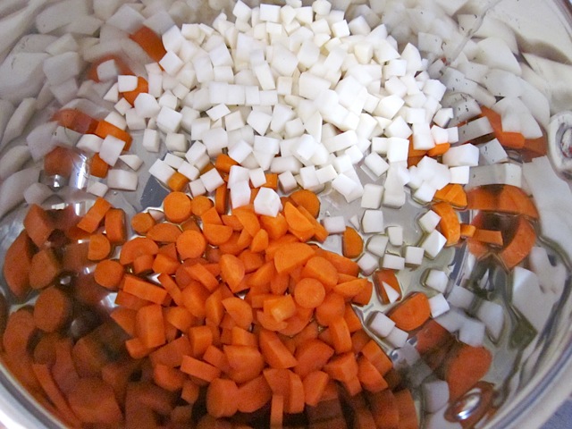 diced turnips and carrots in pot 