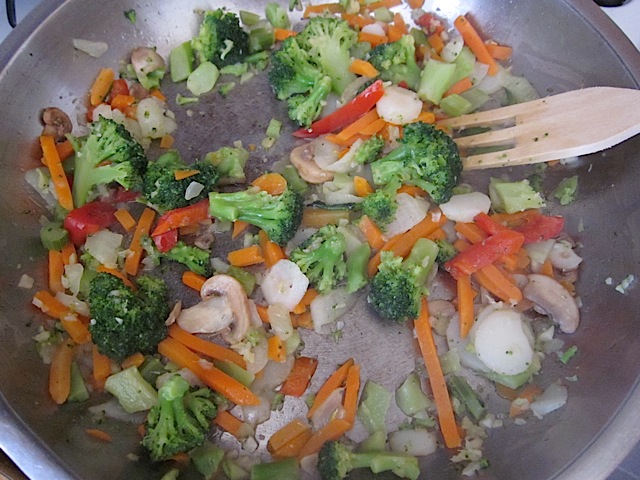 Frozen stir fry veggies added to pan 