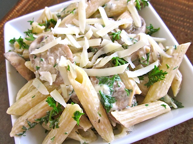 bowl of chicken mushroom pasta topped with parmesan