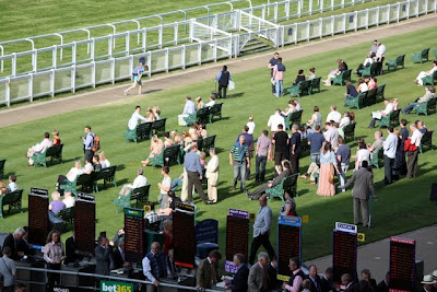 Crowds on the field at Ascot Racecourse in Berkshire England