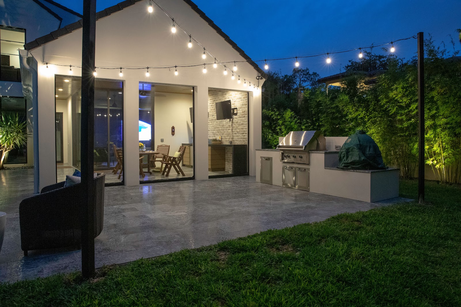 outdoor string lights over patio and grill