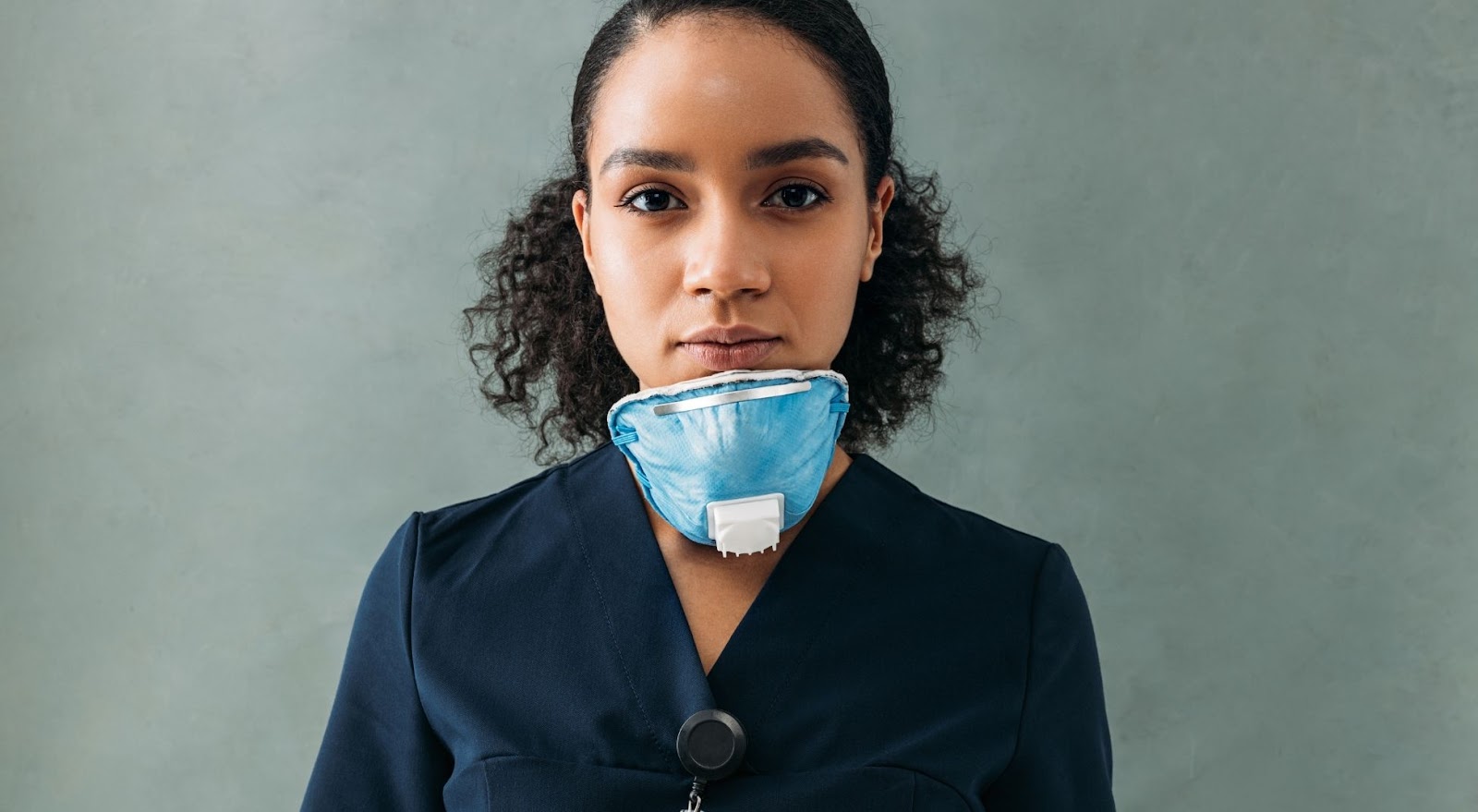 trusted female doctor looking at camera with mask