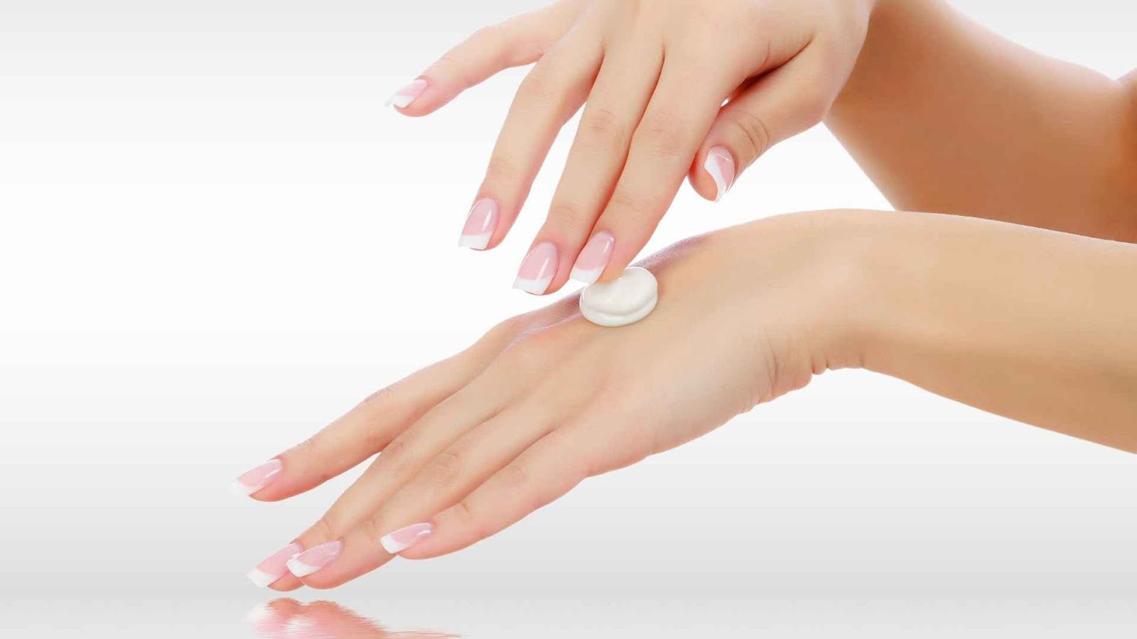 A woman putting moisturizer on her hand