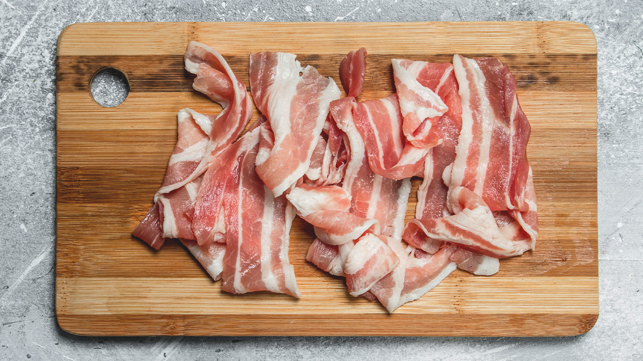A tiny bit of raw bacon shouldn’t do much harm. - Healthline