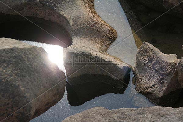 Reflection of sun in potholes