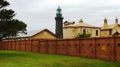 The grassed-in moat and the walls of Fort Queenscliff, signal tower and lighthouse
