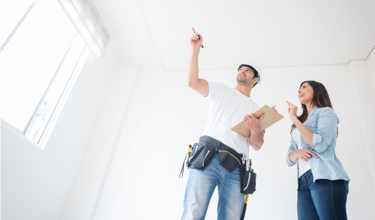 A woman speaks with her contractor about how she’d like to remodel a room in her house.