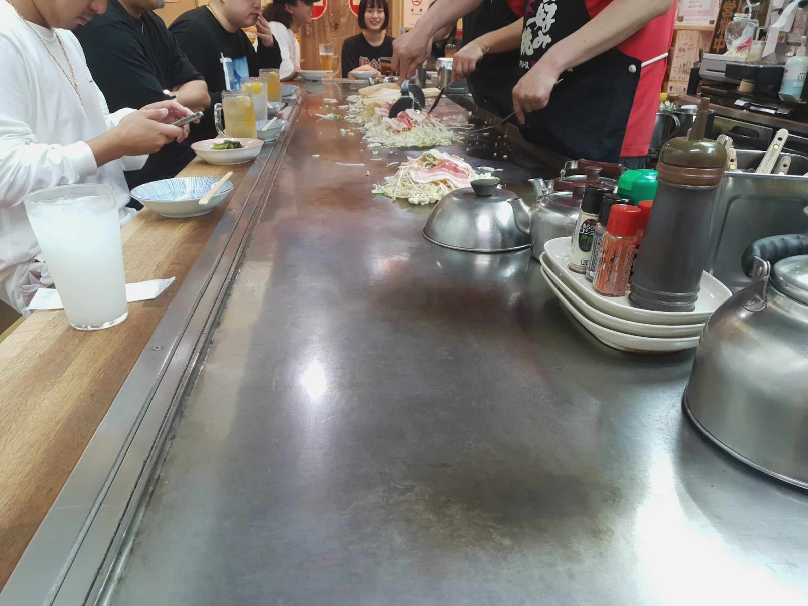 staff at Daimarudo in Okonomimura cooking okonomiyaki