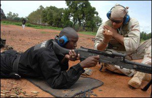 A Navy sailor instructs a Malian police officer