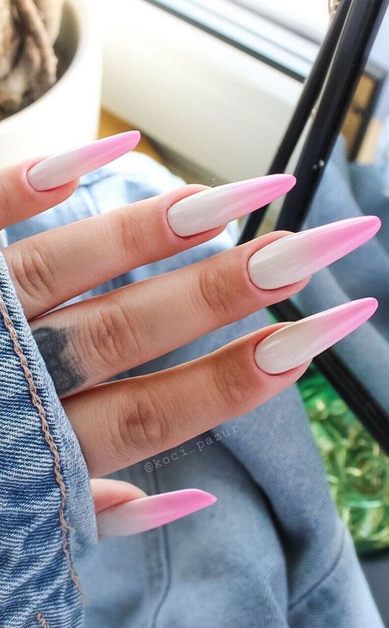 lady shows off her hands rocking the pink ombre nails design