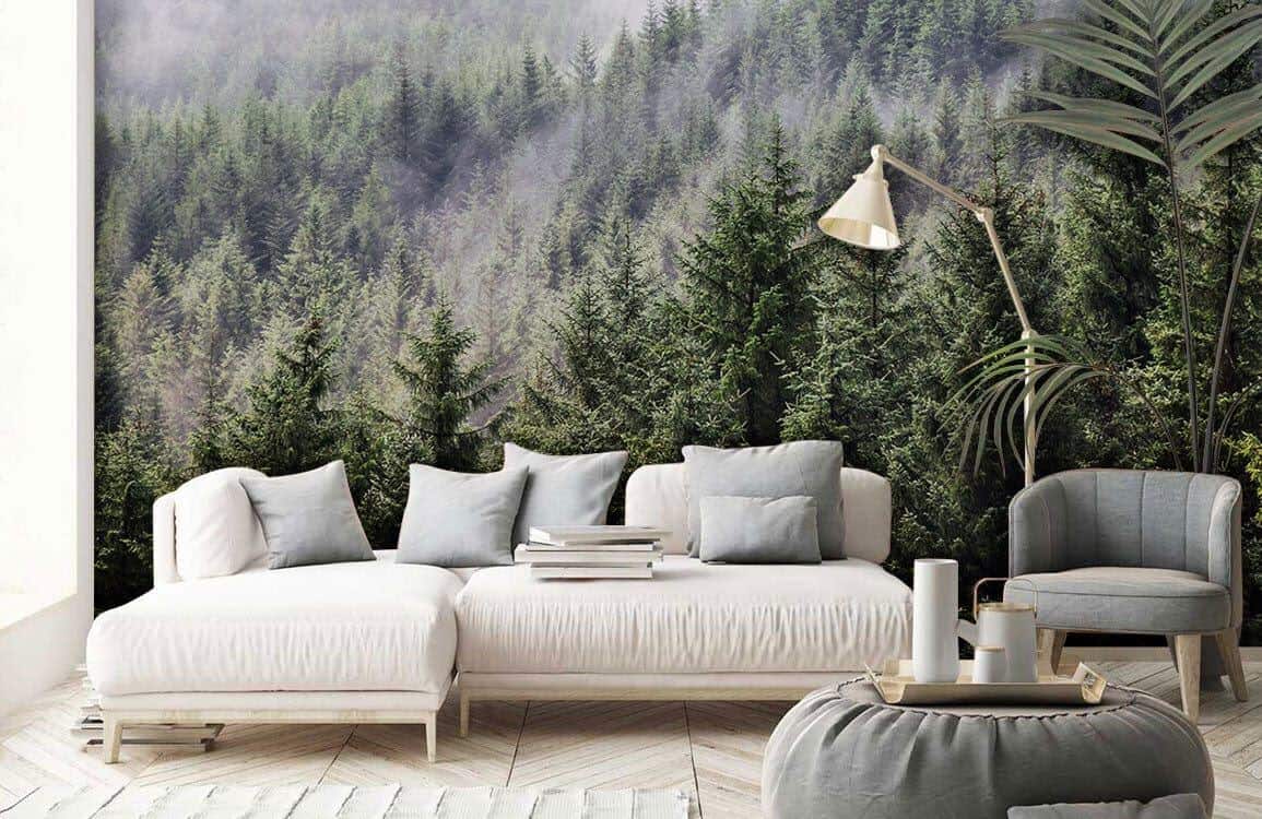 Ever Wallpaper mural of a forest covered in mist behind a minimalist white sofa  and a grey pouffe
