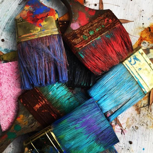 Paint brushes covered in paint