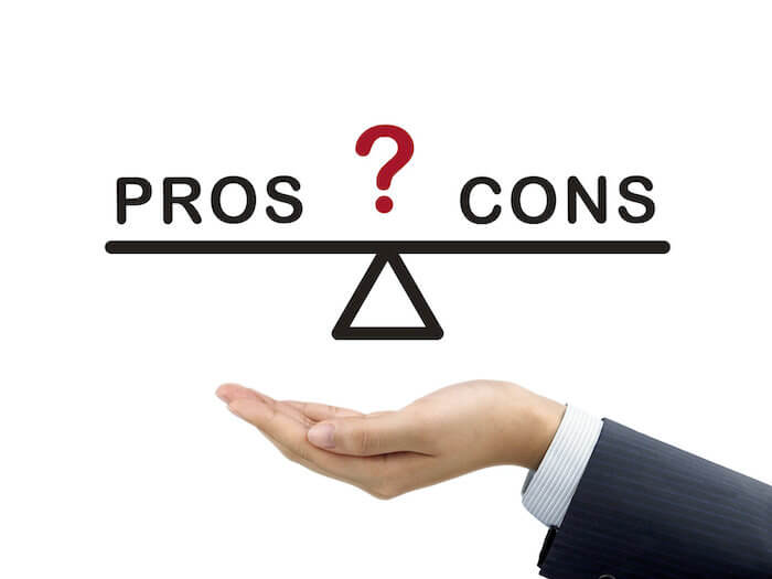 Illustration of hand weighing a scale of pros and cons