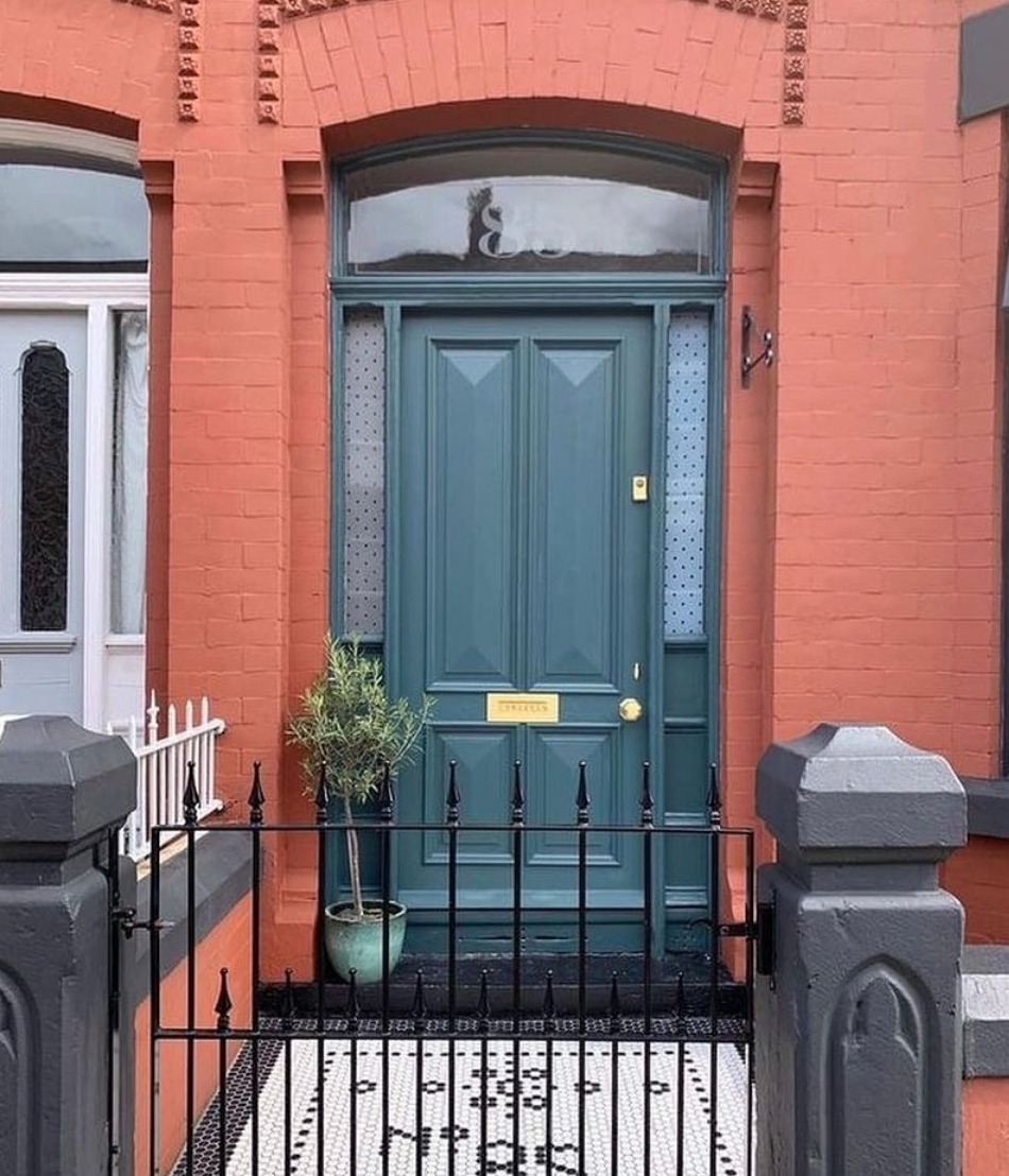 Red brick house with a inchyra blue front door