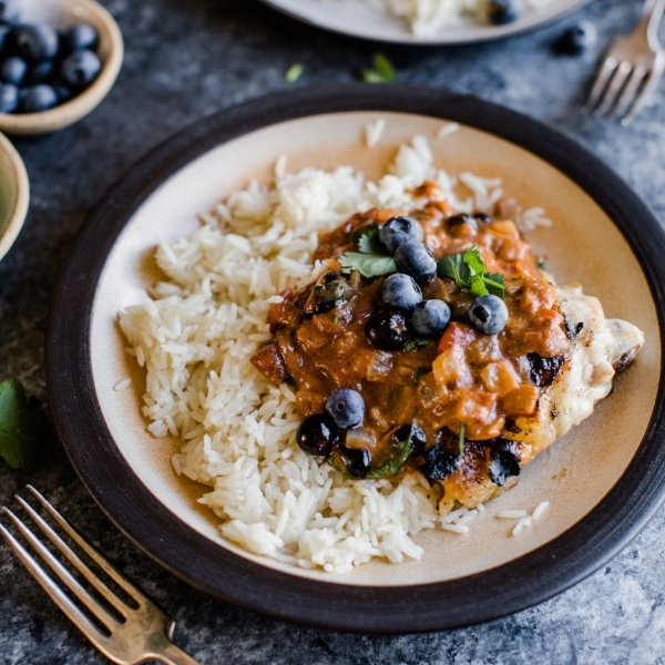 tikka masala on rice topped with blueberries