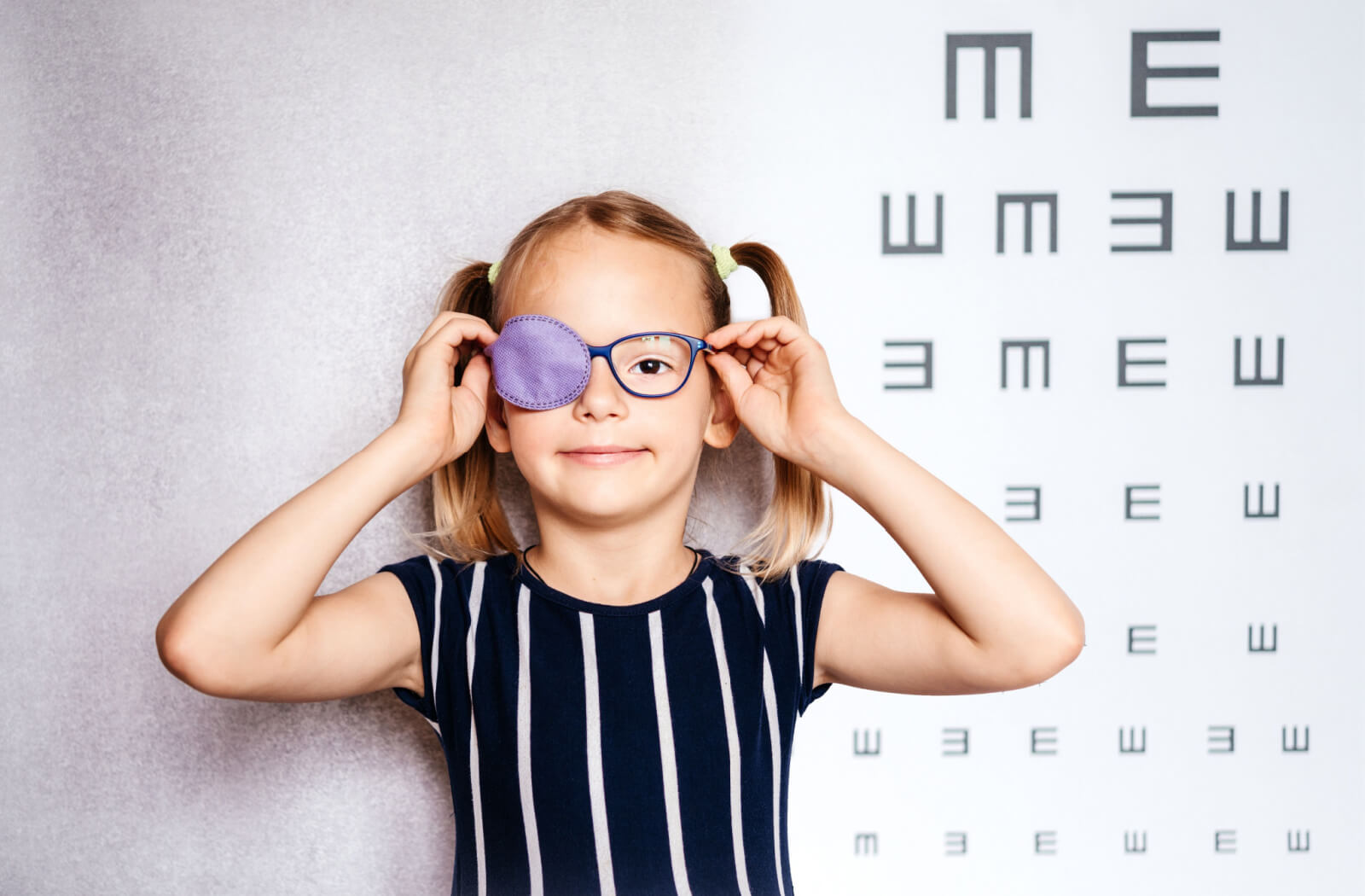 a young girl wears an eyepatch to treat amblyopia