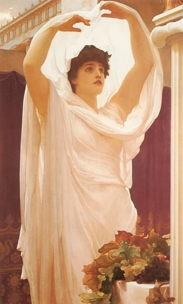 Vesta is in a white dress-like garment, raising both hands above her head.
