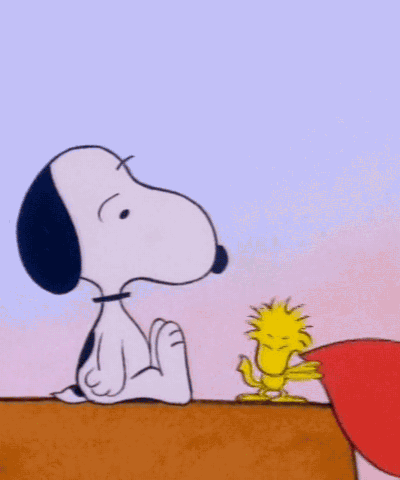 Woodstock slapping Snoopy in the face with a red paper heart.