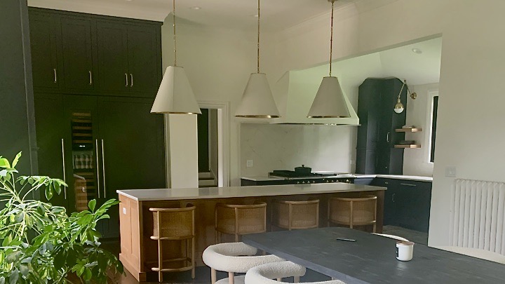 kitchen-remodel-with-navy-blue-cabinetry-natural-wood-island-quartz-countertops-and-shaded-pendants.