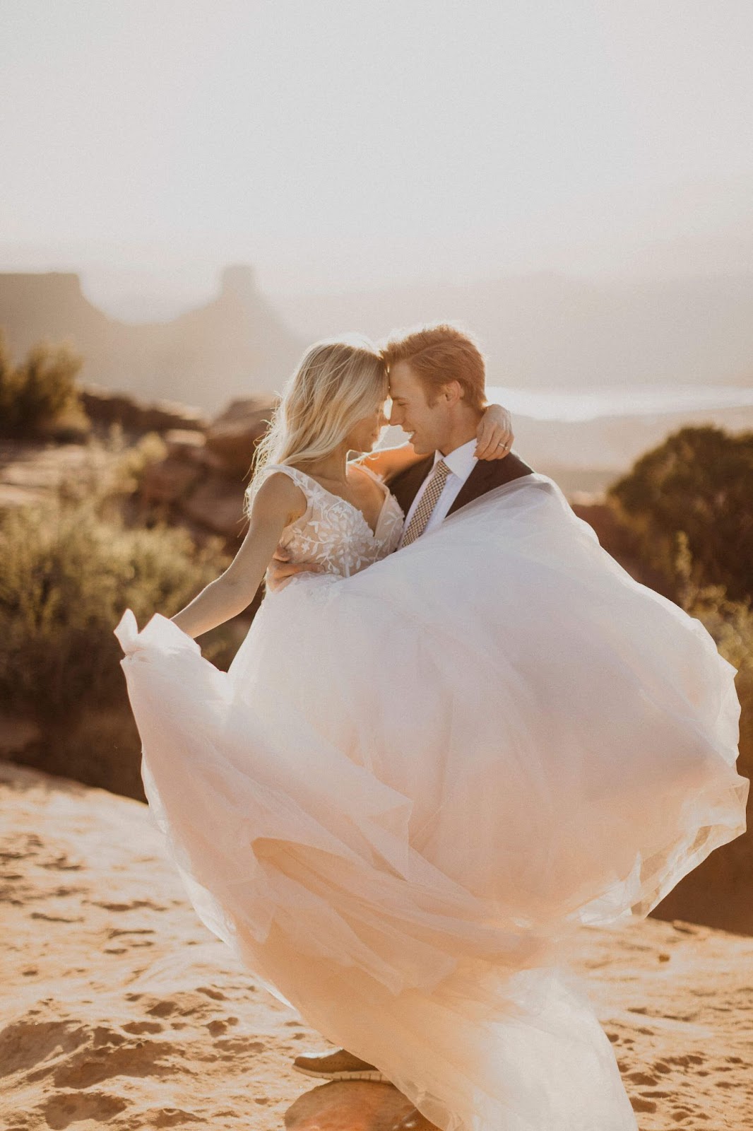 groom holding bride in Moab