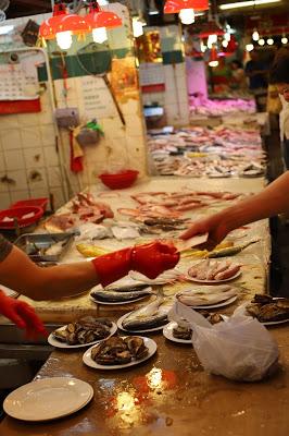 Someone buying fish at the Marketplace