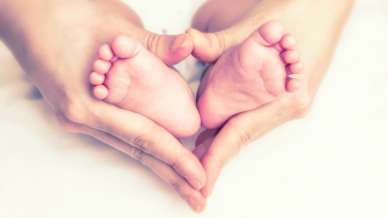 mother holding baby's leg symbol of love