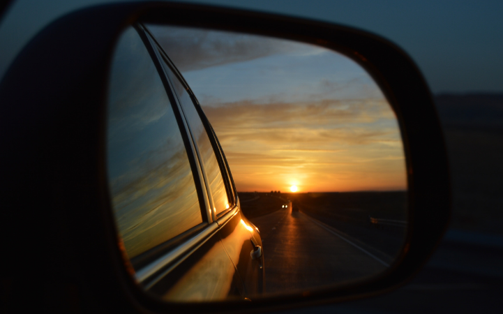 view of sunset through car mirror