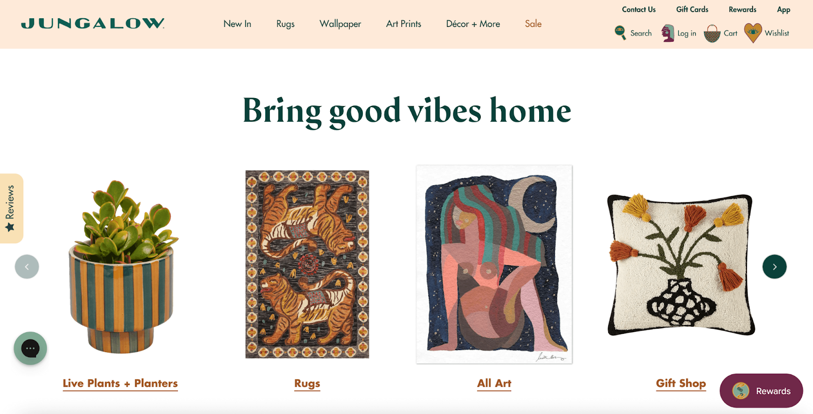Support Black-owned businesses–A screenshot from Jungalow’s homepage. The section title is ‘Bring good vibes home’. Below are four product images for four of their product categories: a striped blue planter for ‘Live Plants and Planters’, a multicolored rug with two tigers on it for ‘Rugs’, a multicolored print of a women sitting in front of a starry sky for ‘All Art’, and a pillow with a vase and flowers in it for ‘Gift Shop’. 