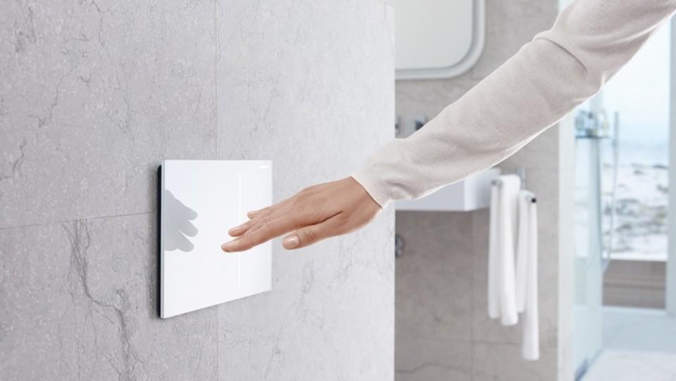 image of a hand using a smart flush plate
