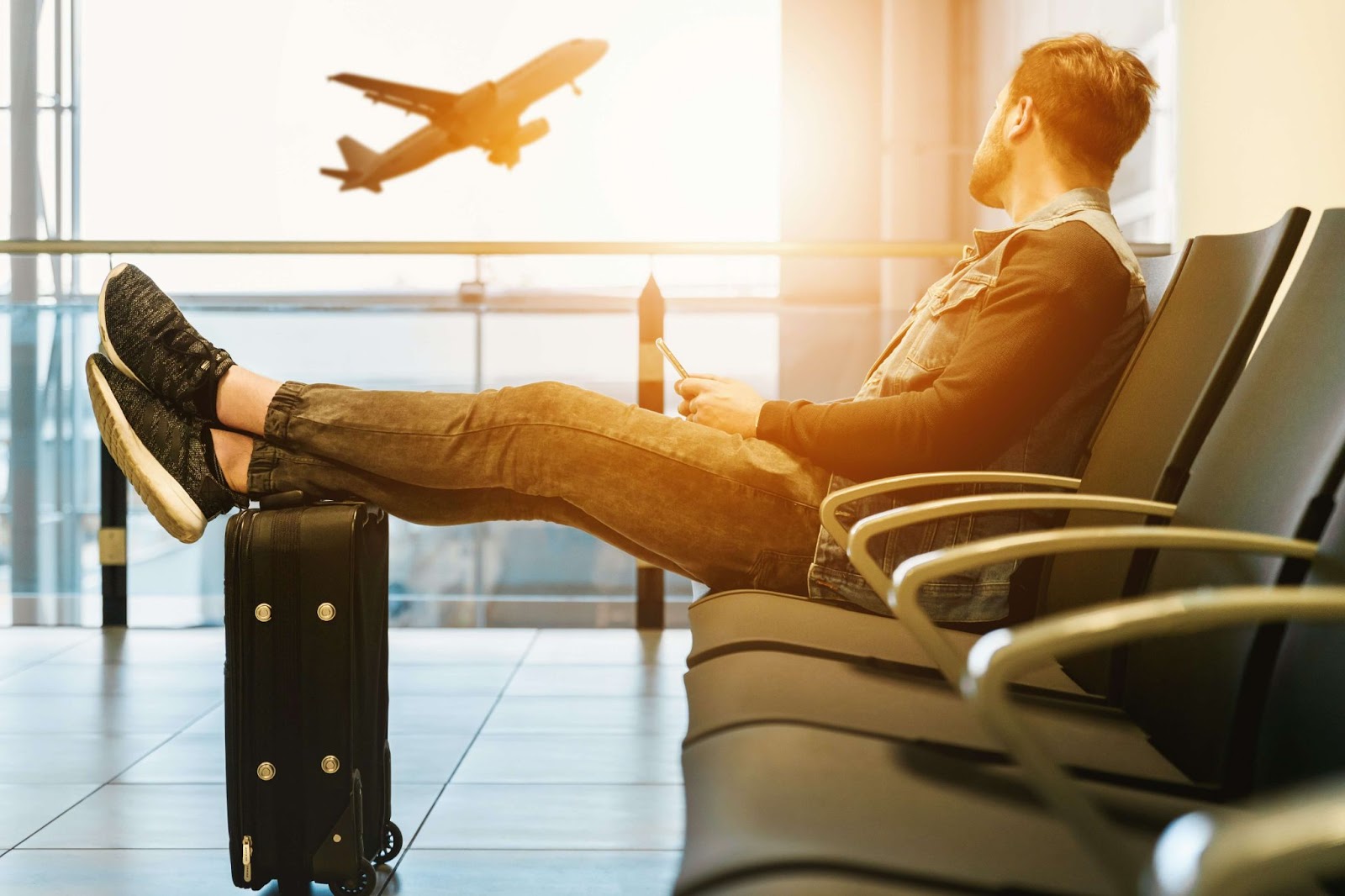 guy waiting on airplane lobby