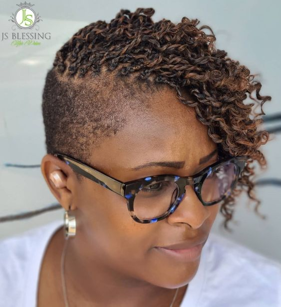 Side view of a lady rocking this hairdo with a  shaved cut 
