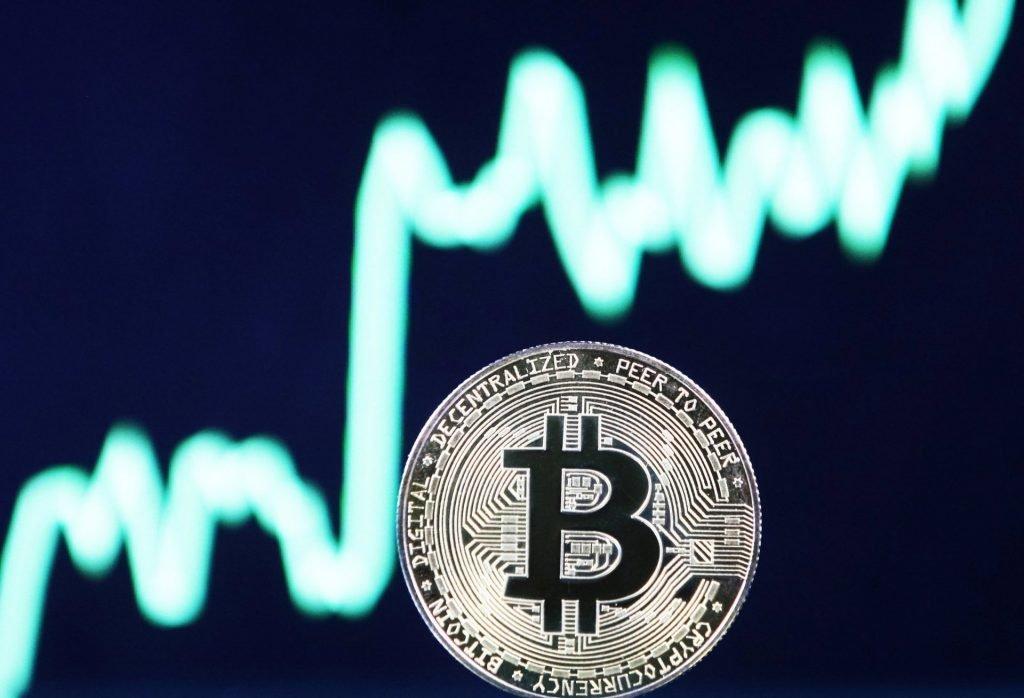 Bitcoin in front of a crypto price chart 
