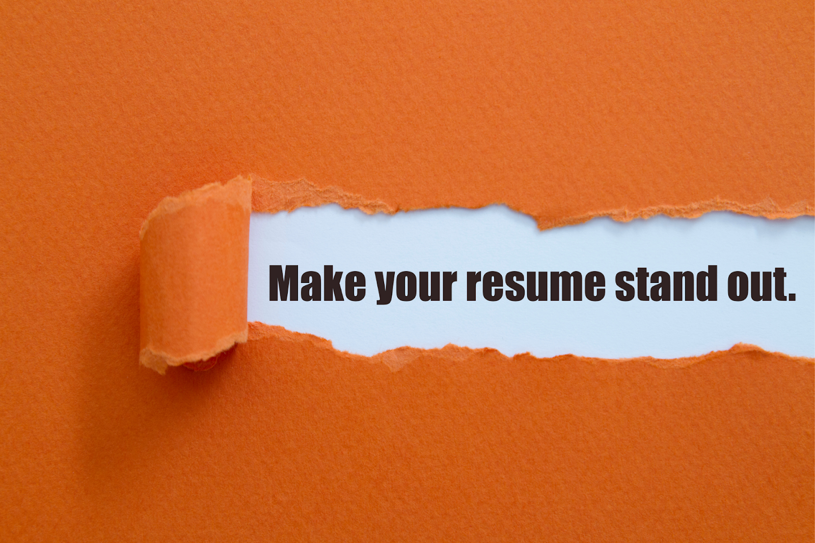 “Make your resume stand out” written on a piece of paper

