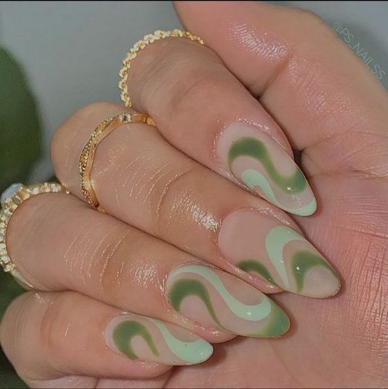 Green nail design with swirls