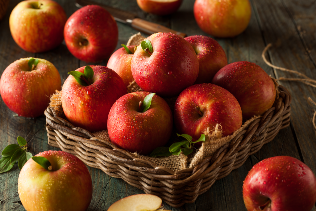 Japanese red apples sitting in a woven brown basket Traditional Autumn Flavors of Japan