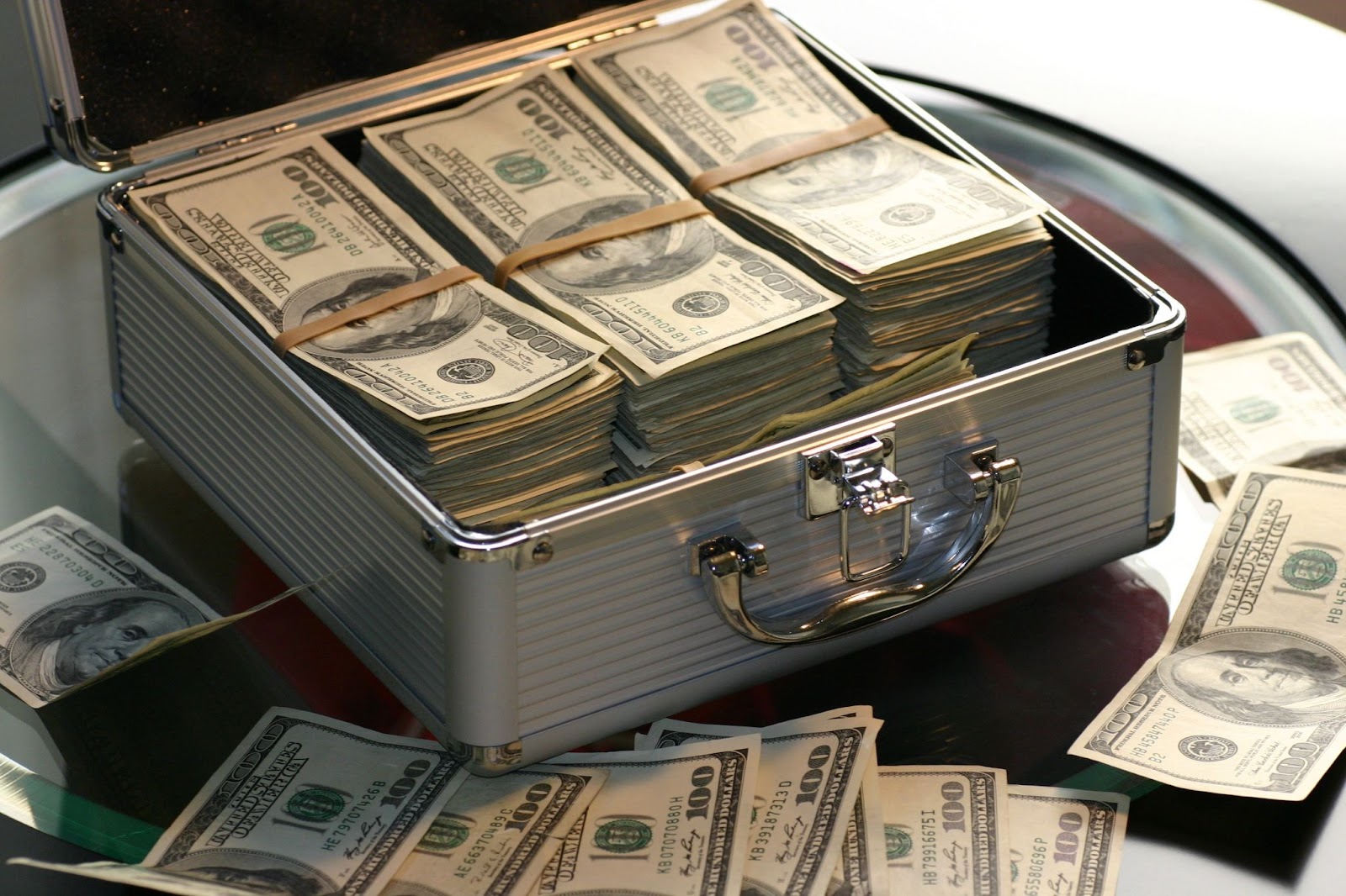 A table with a briefcase of cash offers