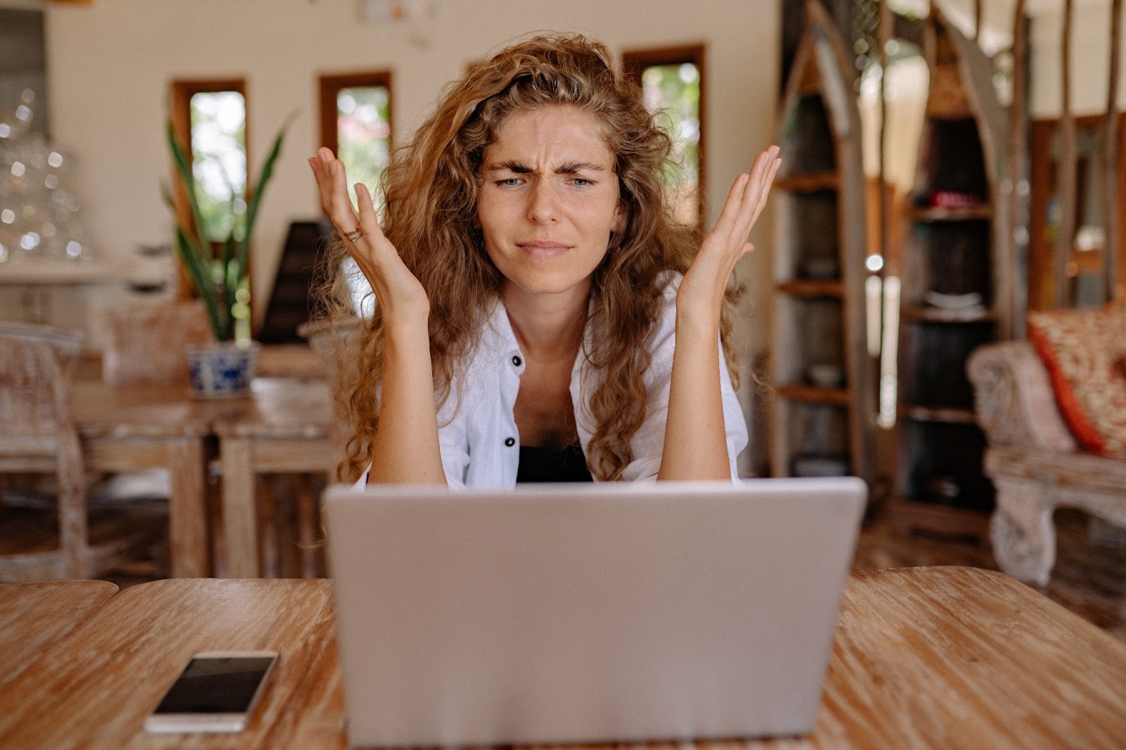 Picture of a frustrated woman in front of her laptop