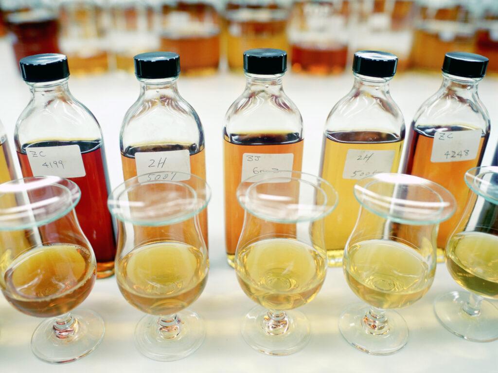A group of bottles and glasses with liquid in them

Description automatically generated with low confidence