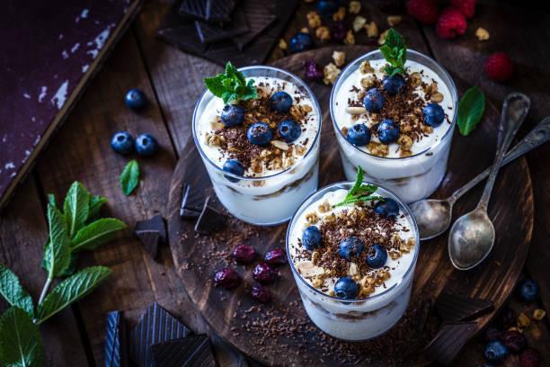 Yogurt with granola, berry fruits and chocolate  greek yogurt stock pictures, royalty-free photos & images