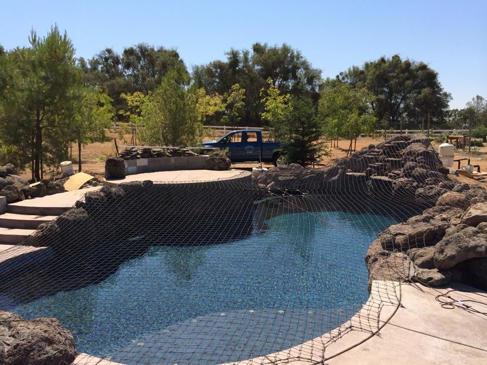 Safety pool net installed on a backyard pool
