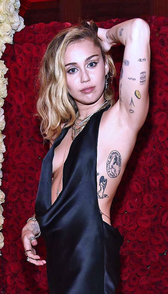 Picture showing Miley Cyrus rocking the patch work tattoo