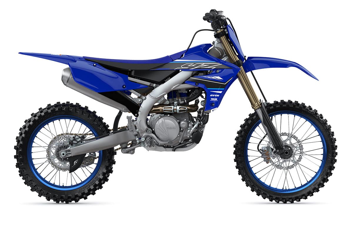 Blue and white Yamaha YZ450F off road motorcycle parked in a display room.