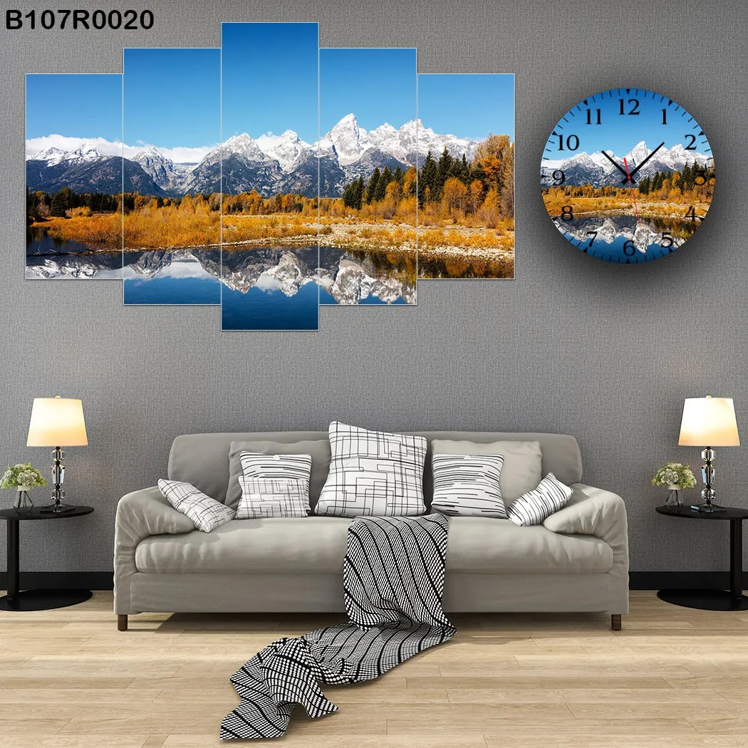 A clock and Picture with natural view of lake, mountains and snow