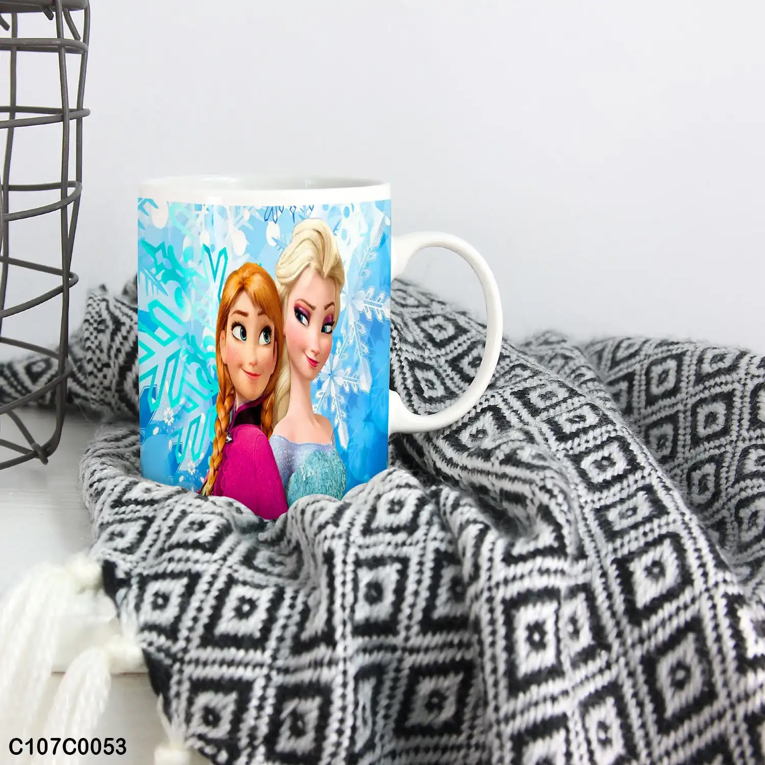 A blue mug (cup) printed with an image of "Elsa & Anna" for children